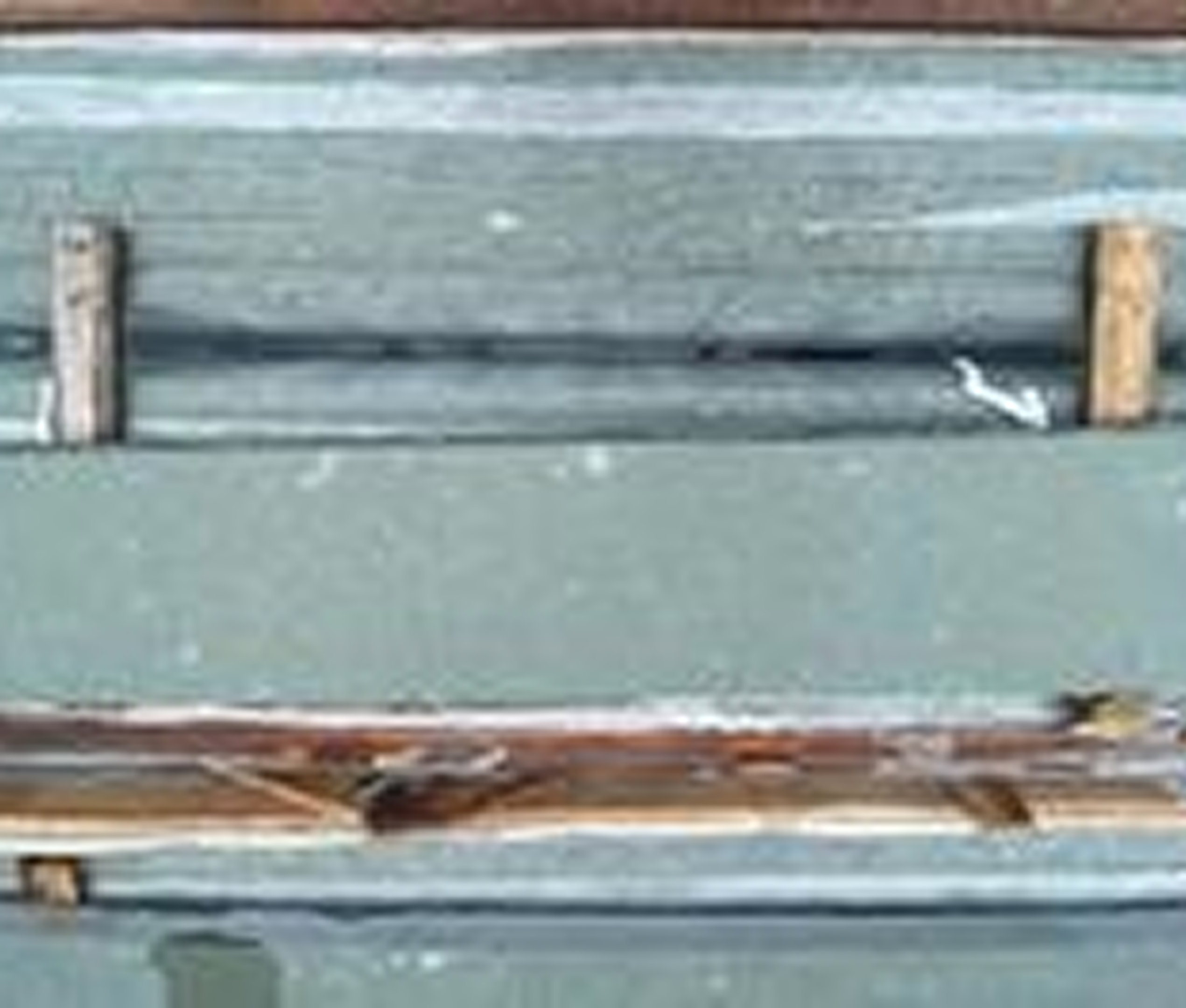 Peeling paint on weathered wooden surface