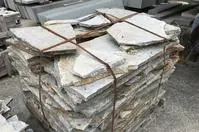 Stacked stone slabs tied with straps