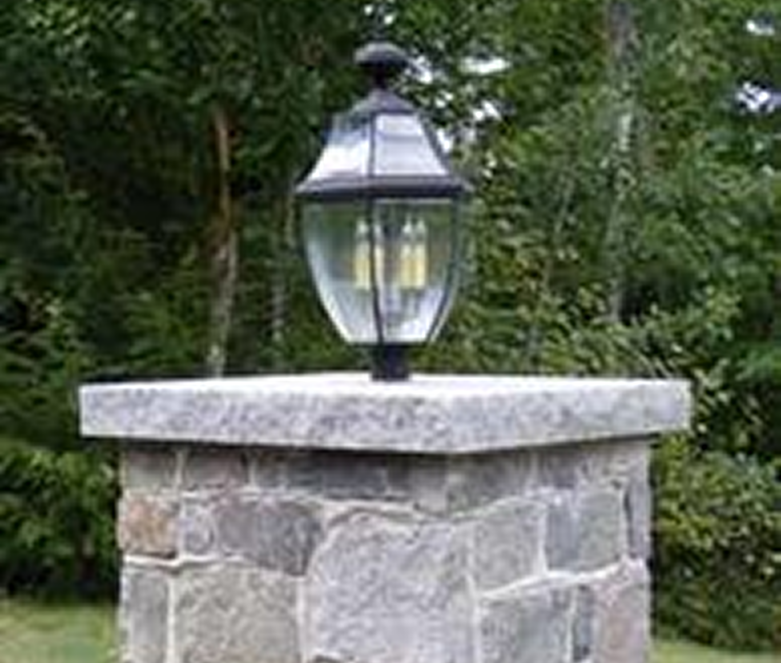 Lantern atop stone post in garden