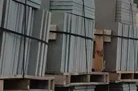 Pallets of concrete slabs in storage.