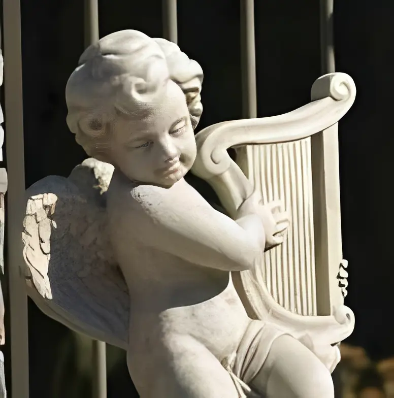 Cherub statue playing a harp