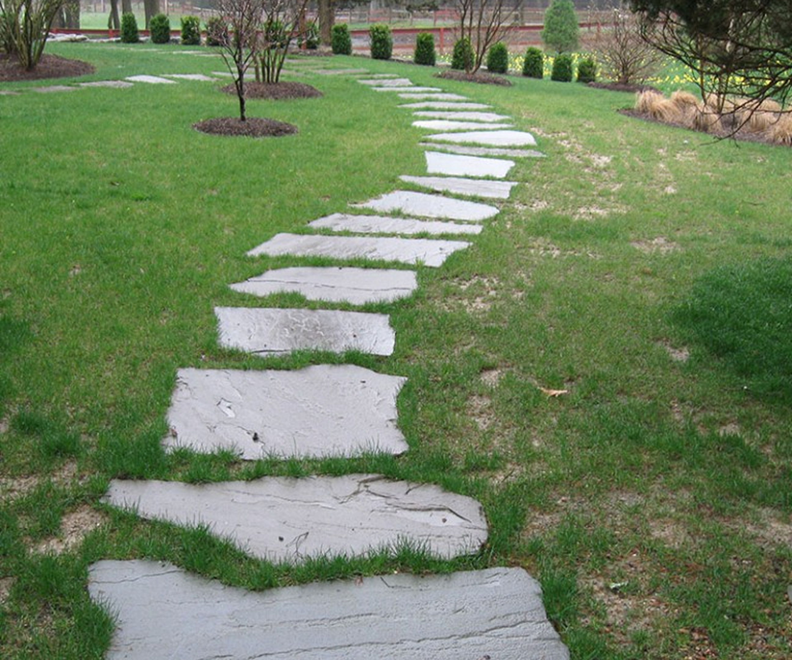 Stone path winding through green lawn