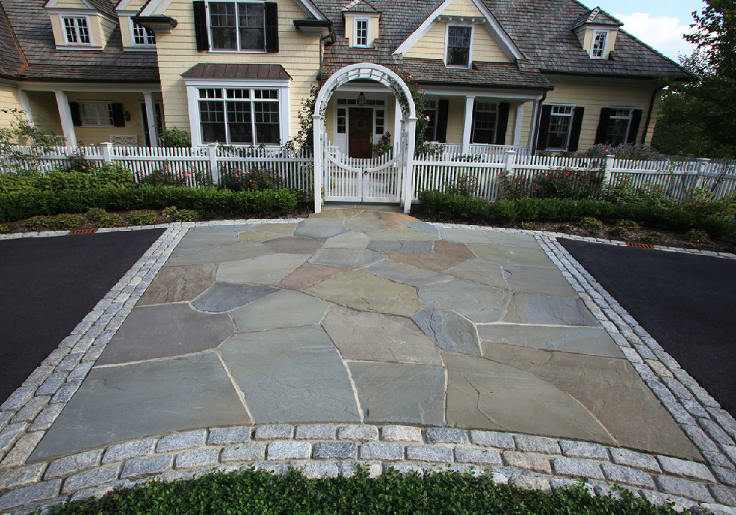 Stone driveway leading to a house entrance
