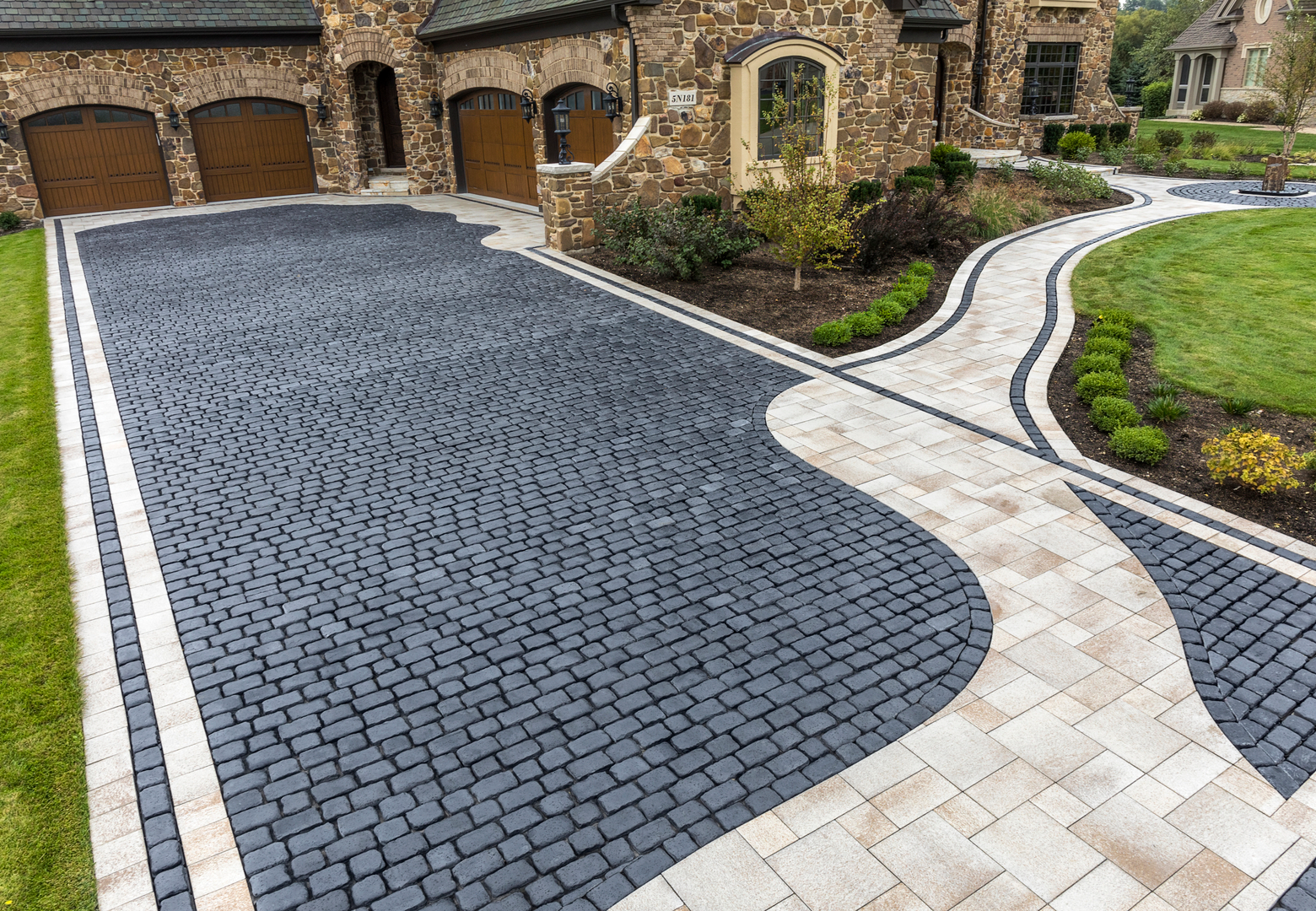 Cobblestone driveway with adjacent paved walkway