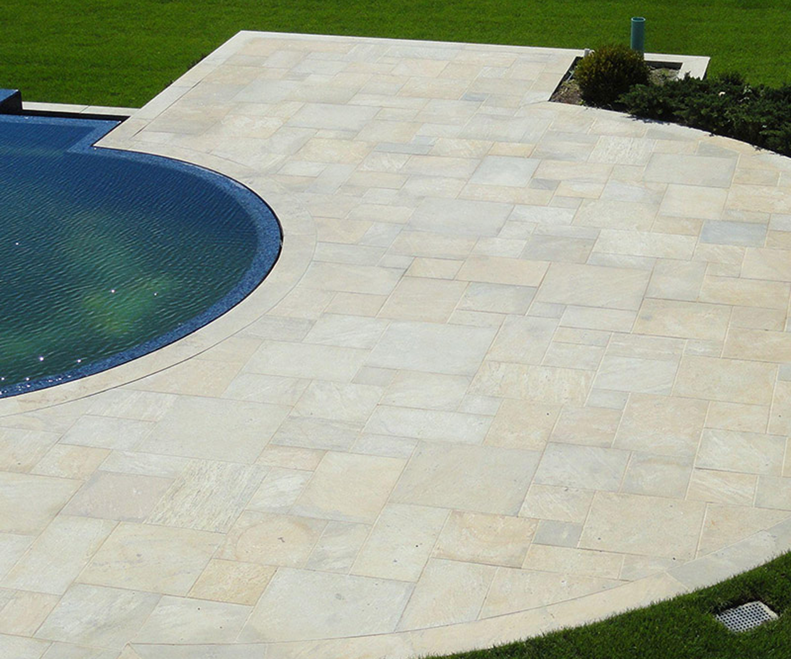 Elegant stone tiles around a blue pool
