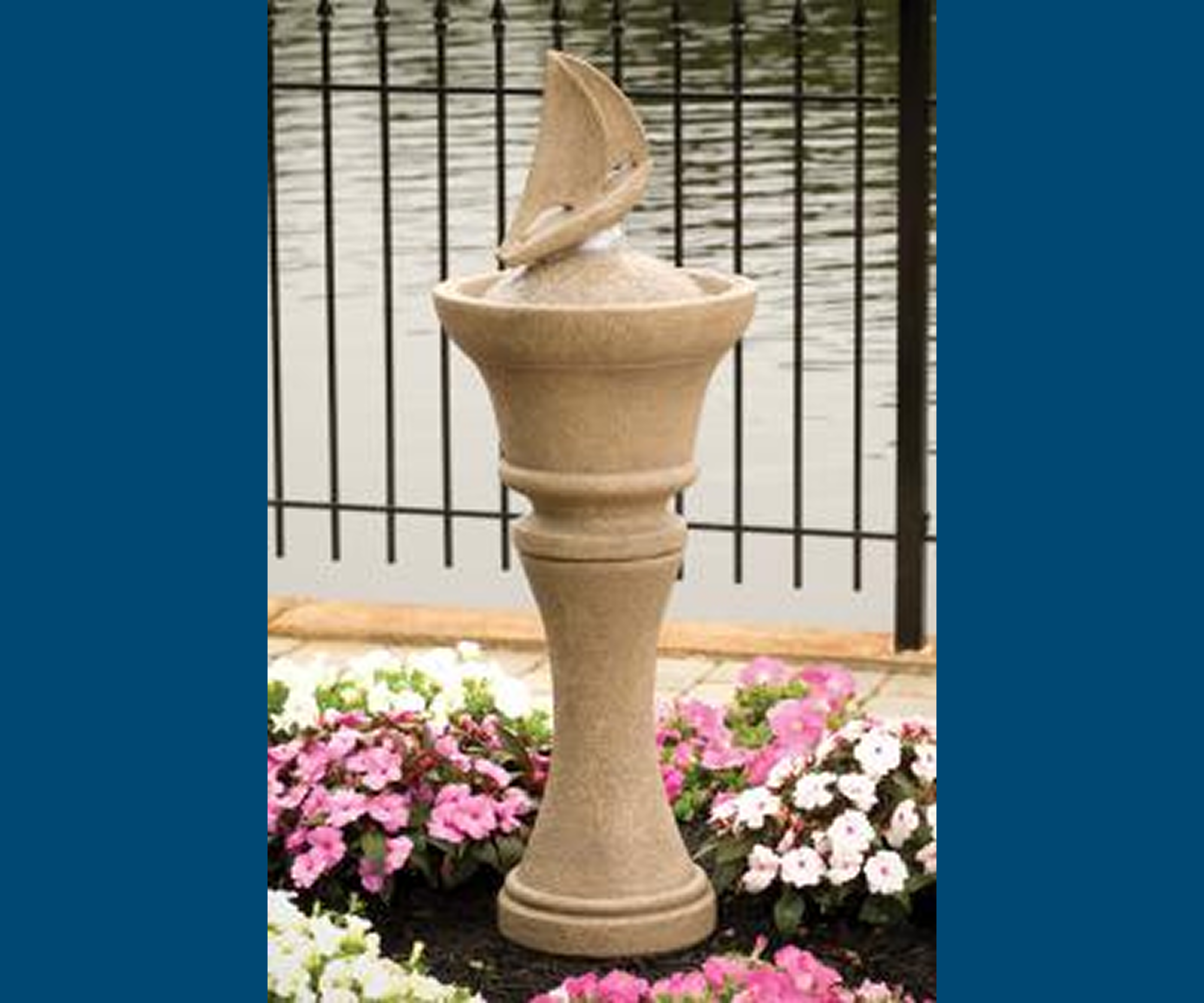 Garden fountain with flowers and lake