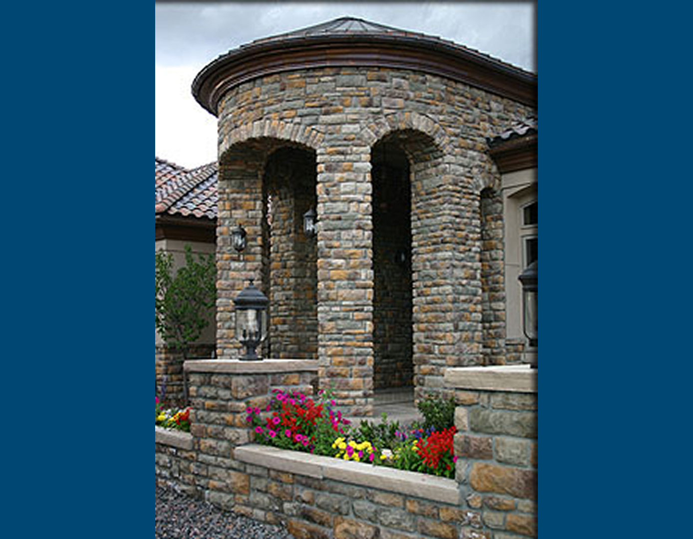 Stone archway with colorful flowers