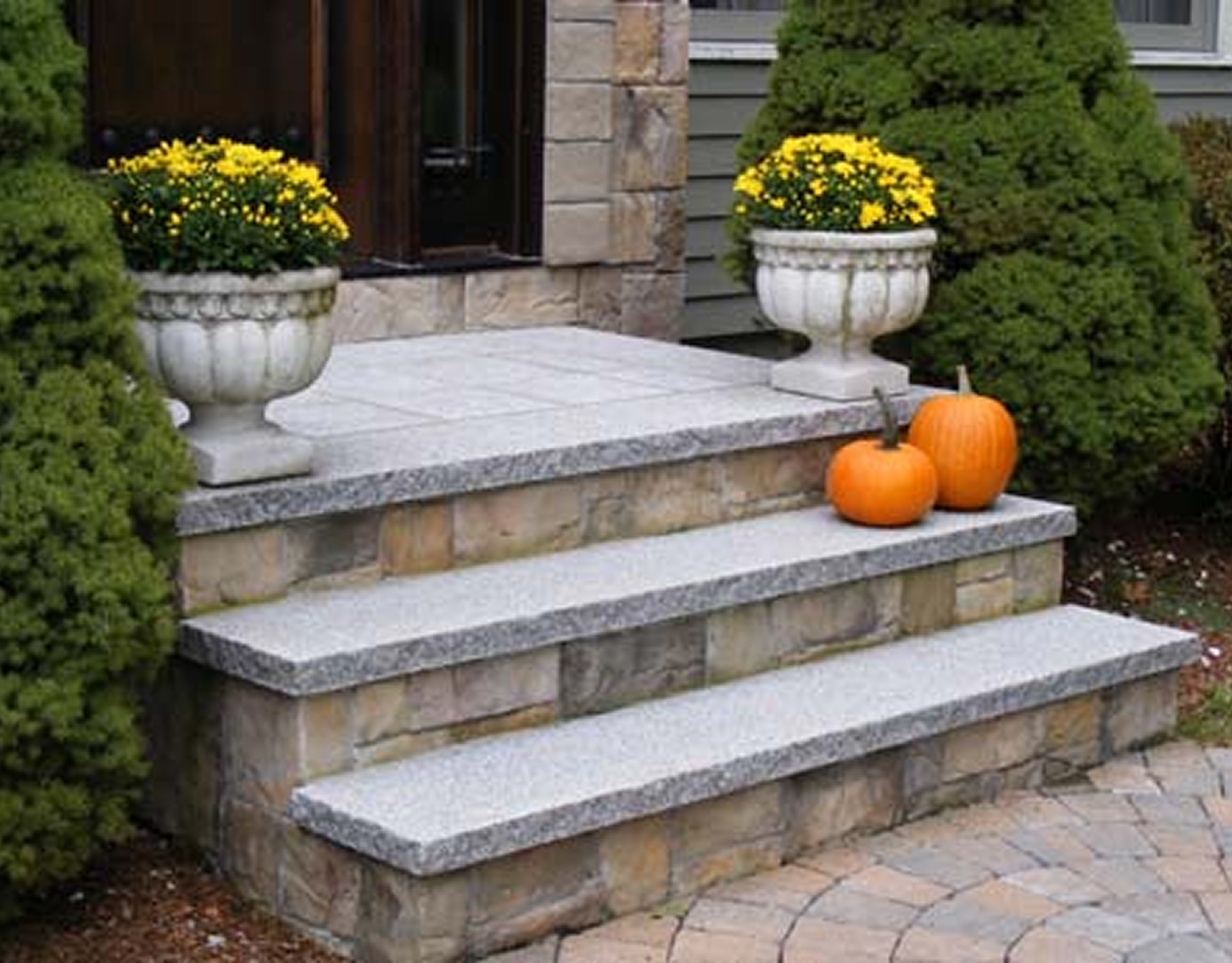 Stone steps with pumpkins and flowers