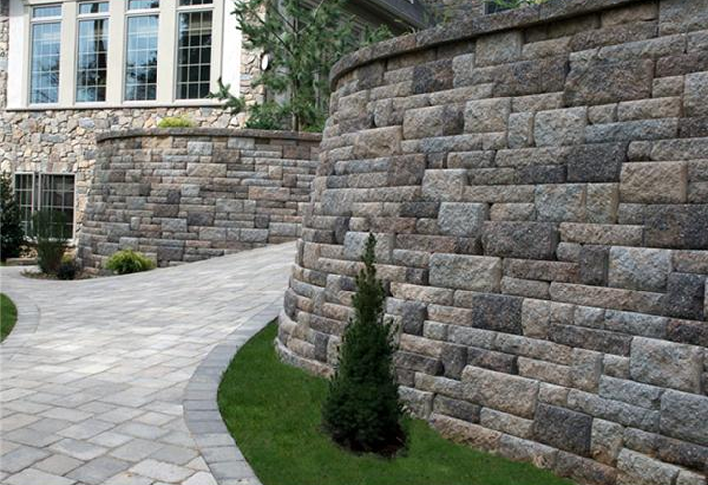 Curved stone wall beside a walkway