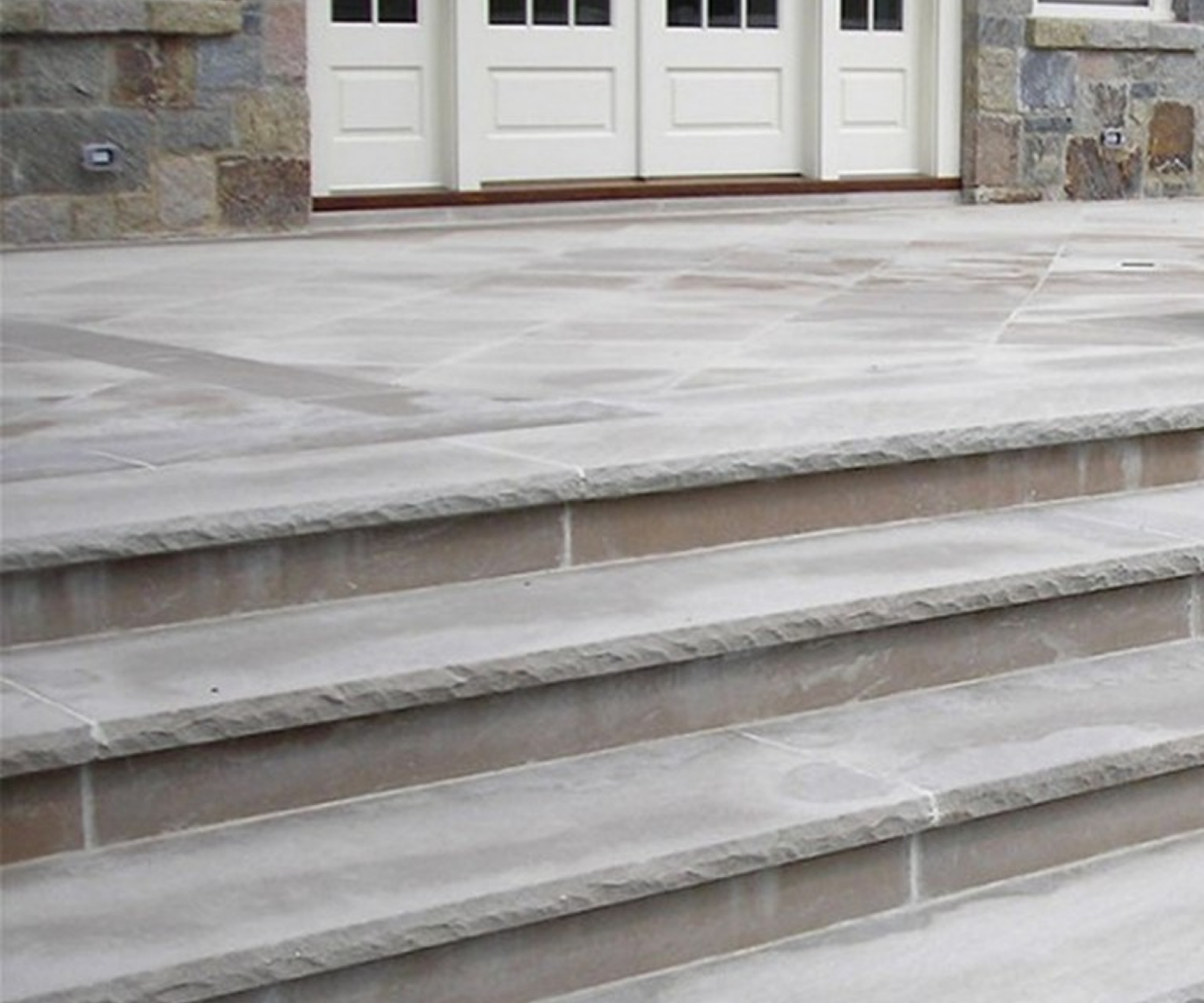 Elegant stone staircase with white entrance