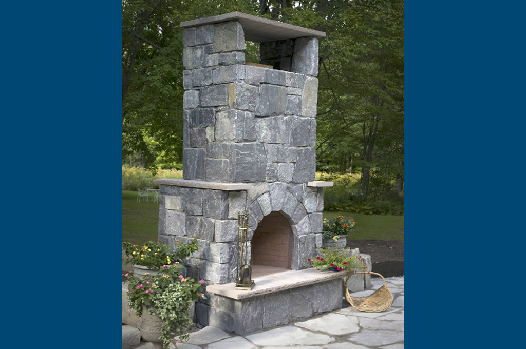 Rustic stone fireplace in garden setting
