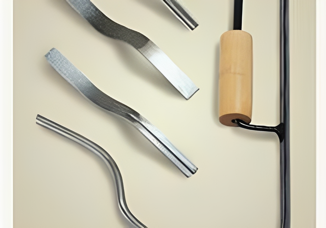 Metallic kitchen tools on a beige background
