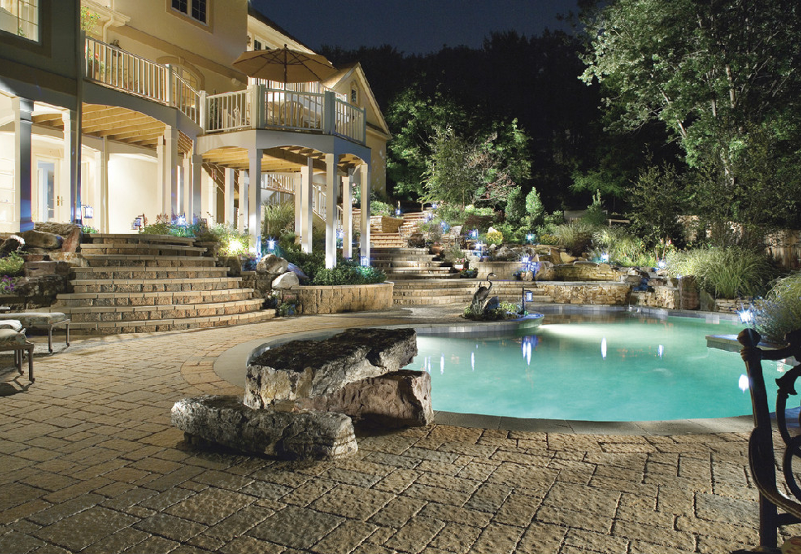 Luxurious backyard pool with stone patio