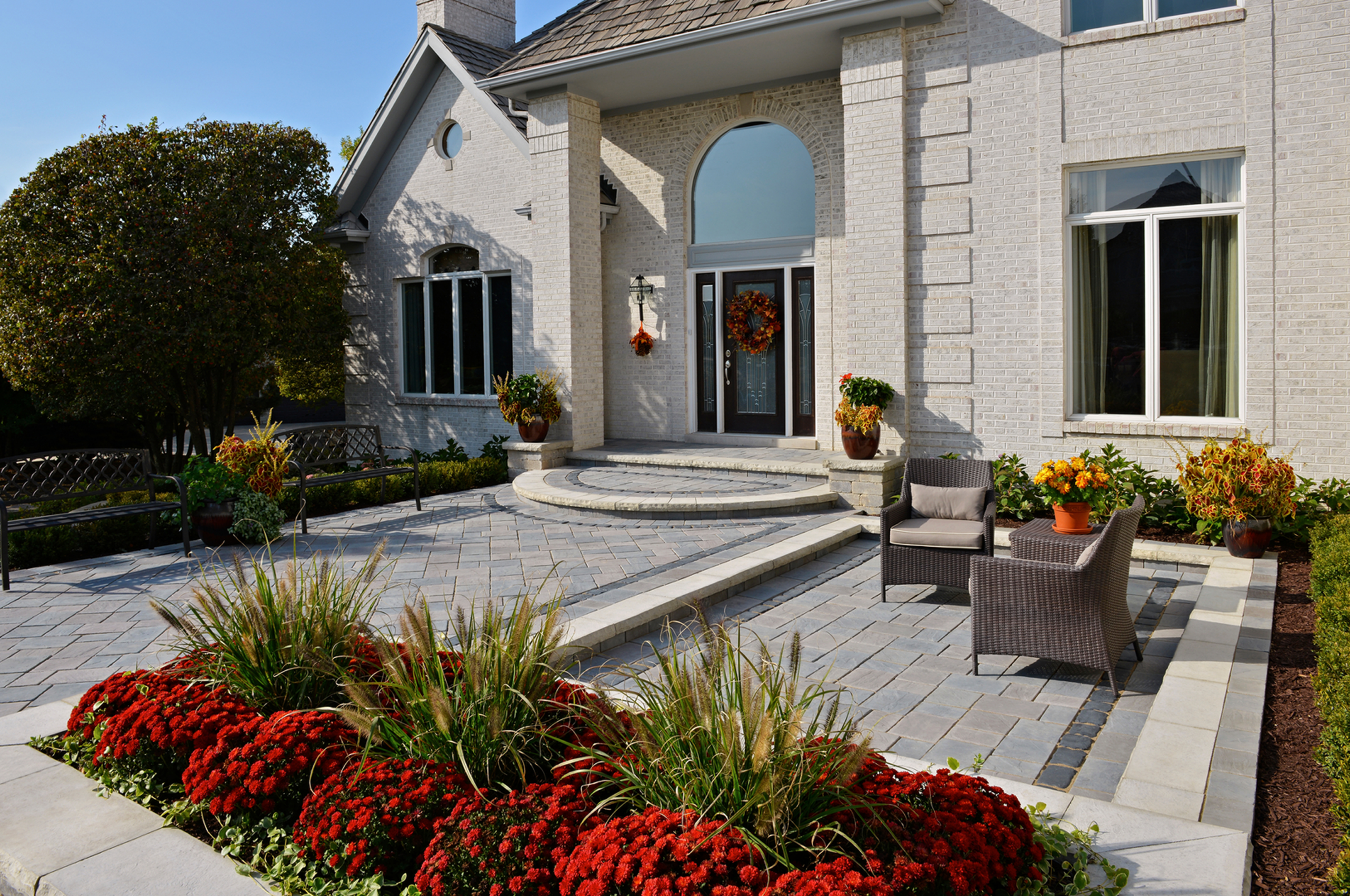 Elegant home with front patio and flowers