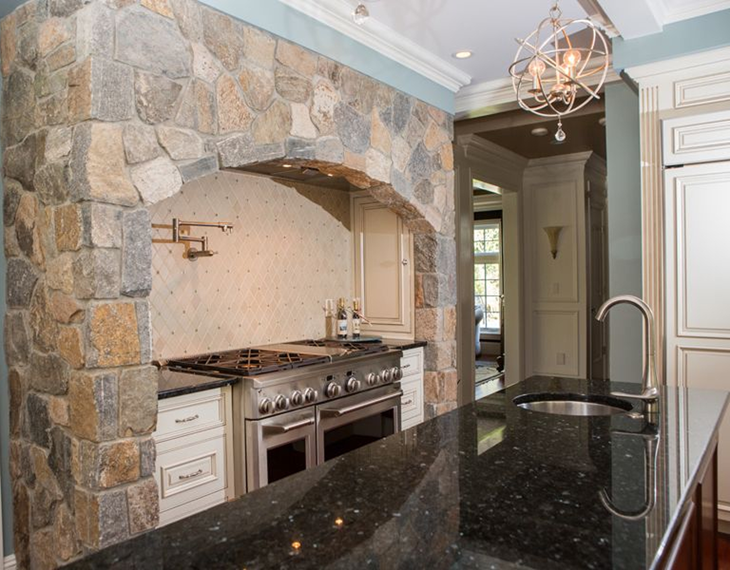 Stone-arched kitchen with modern appliances