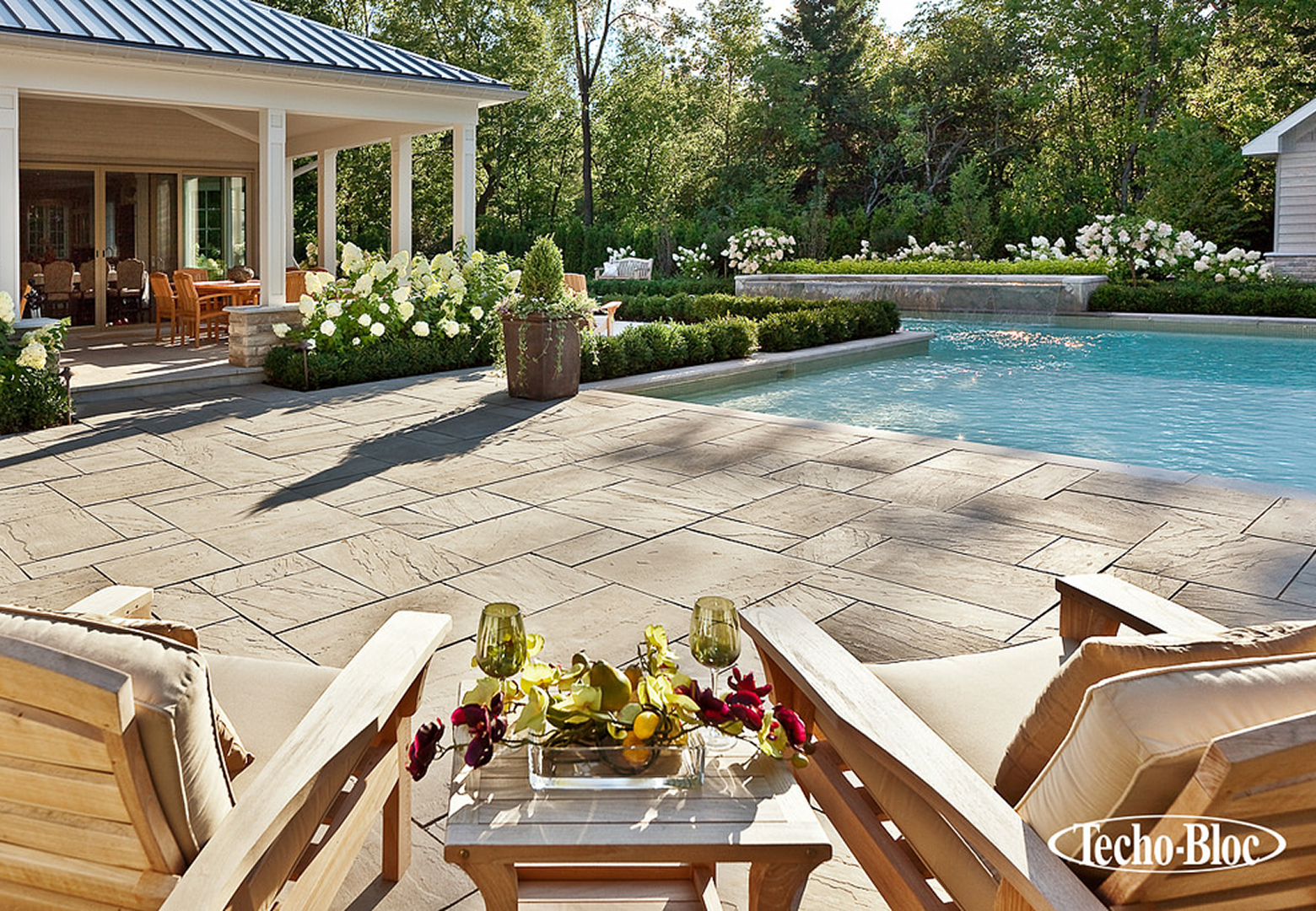 Luxurious backyard with pool and lounge chairs