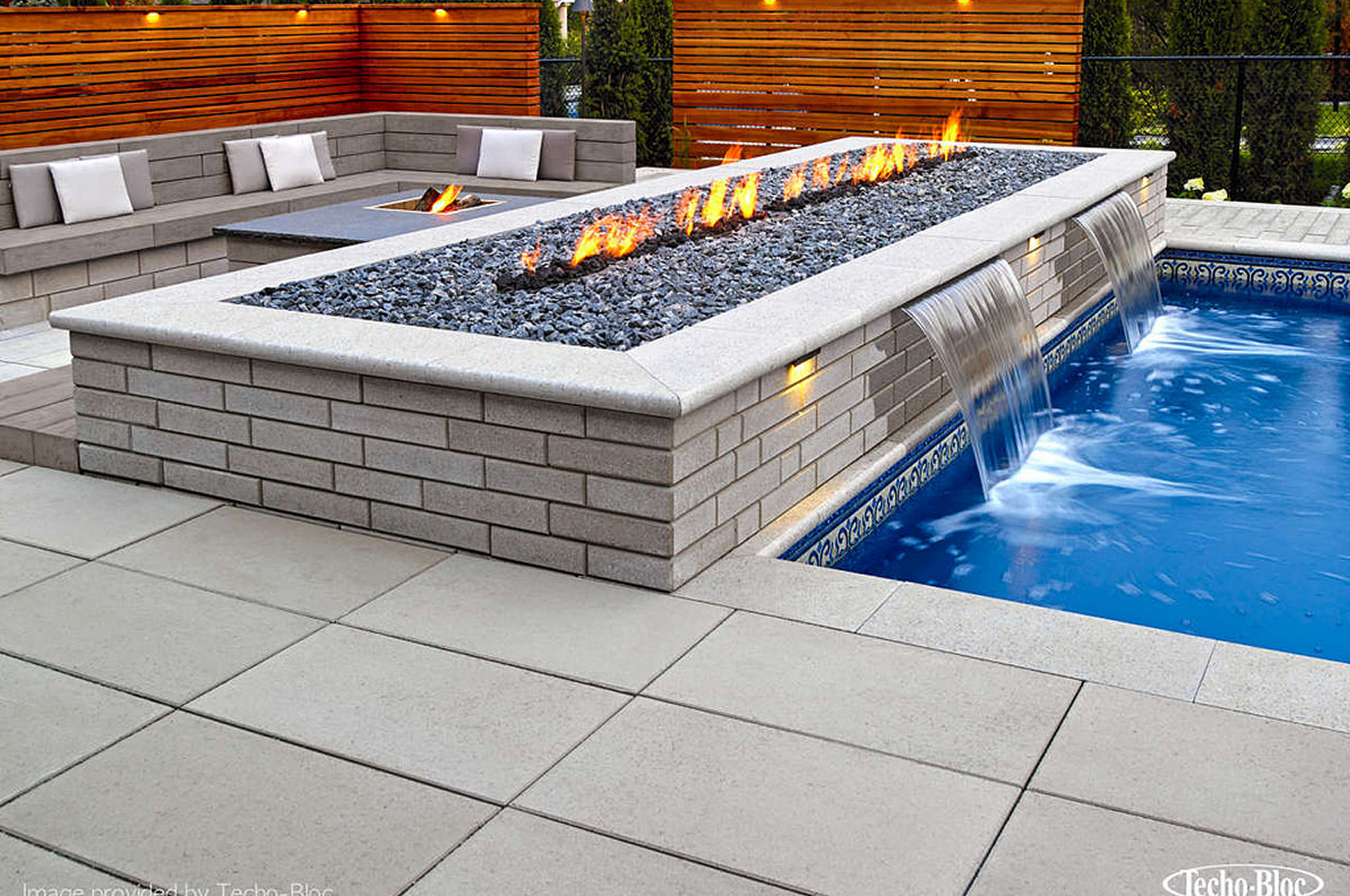 Outdoor seating area beside pool.