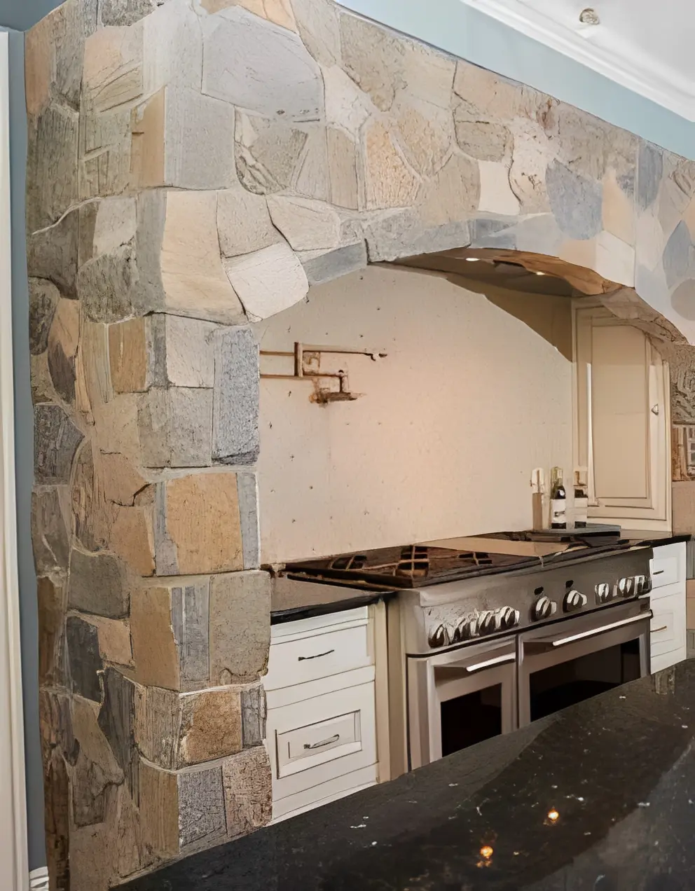 Modern kitchen featuring stone and metal