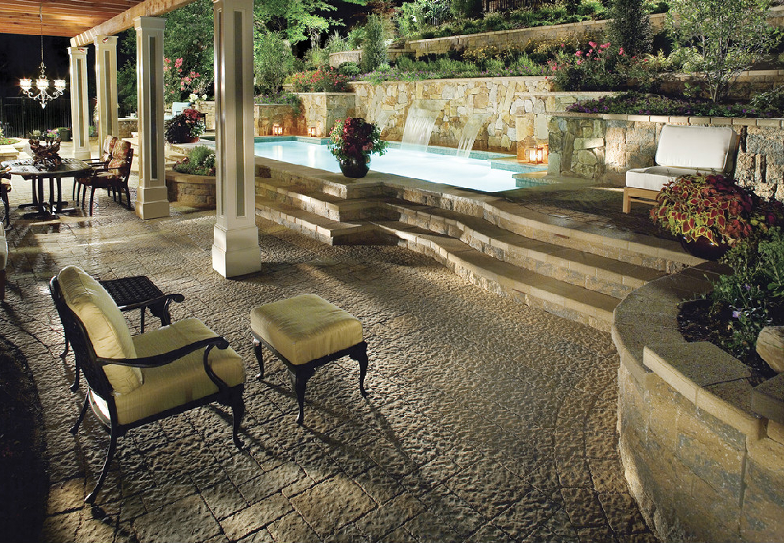 Night-lit outdoor terrace with pool.