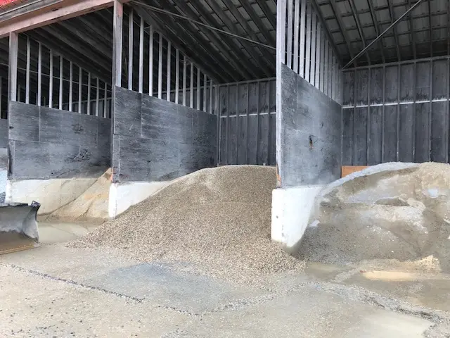 Gravel stored under a wooden shelter