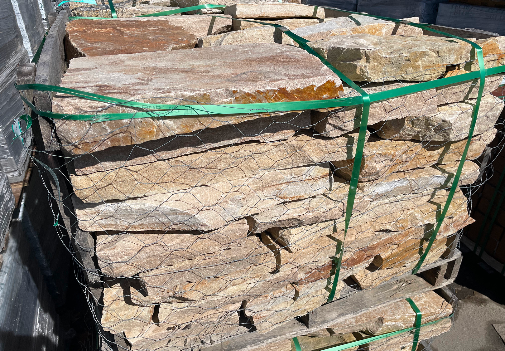 Natural stone slabs secured with green straps