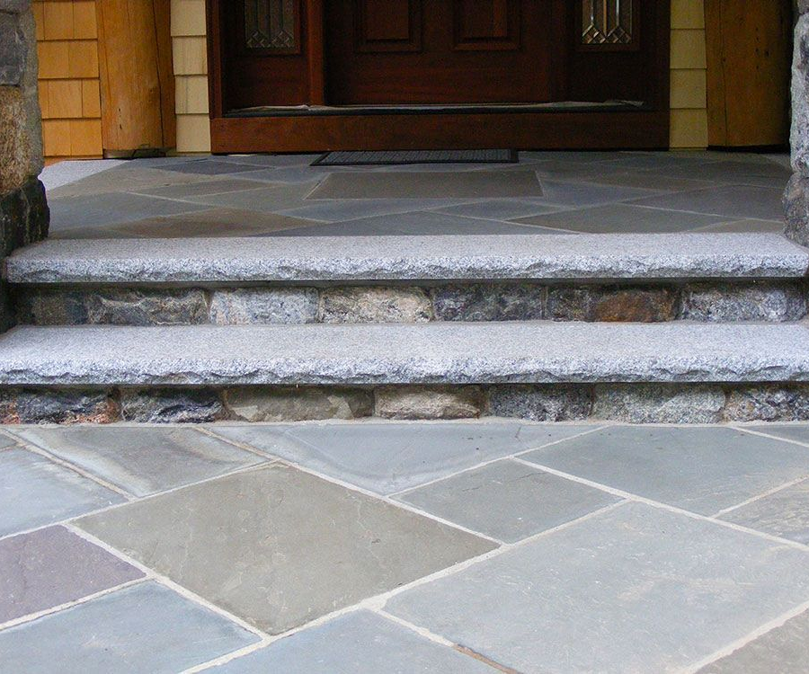 Granite steps with wooden entryway