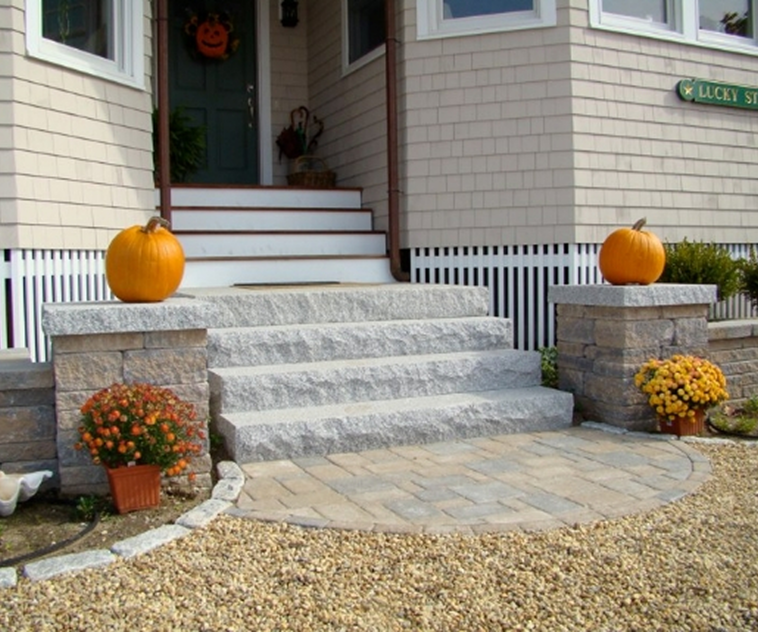 Front porch with pumpkins and chrysanthemums
