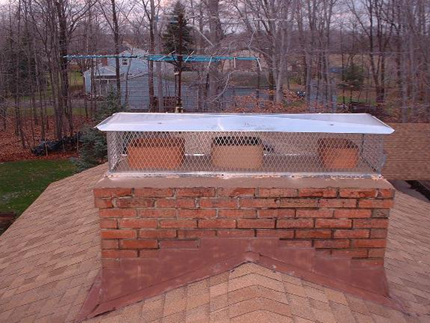 Brick chimney with metal cap