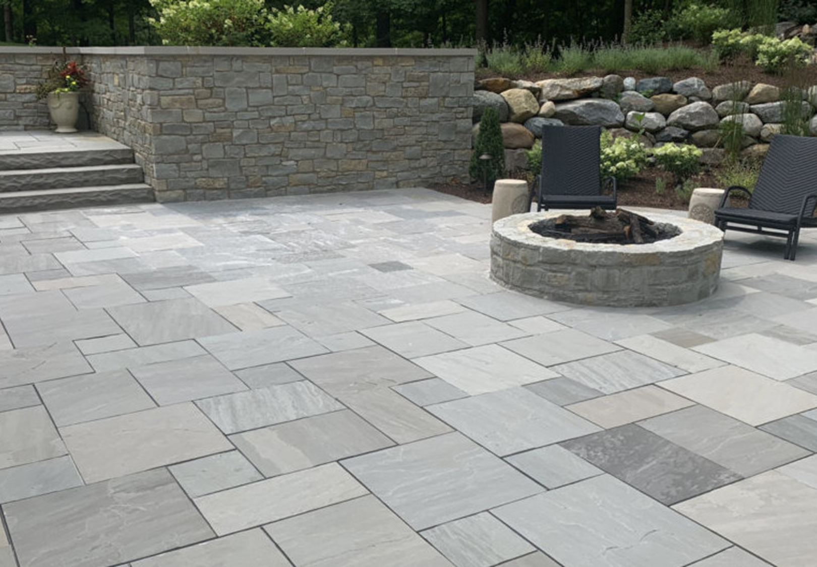 Outdoor stone seating area with fire pit