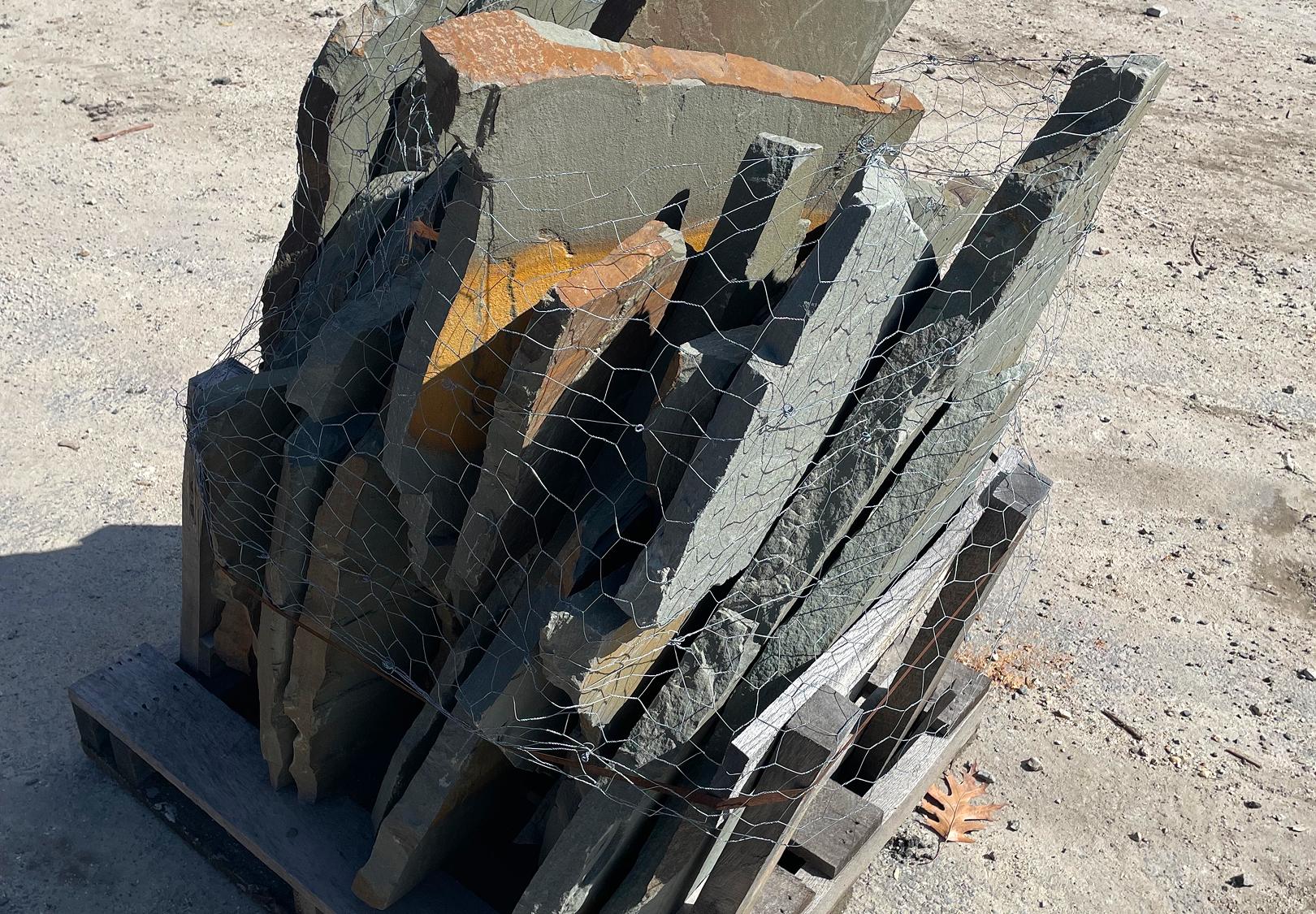 Assorted slate pieces under sunlight