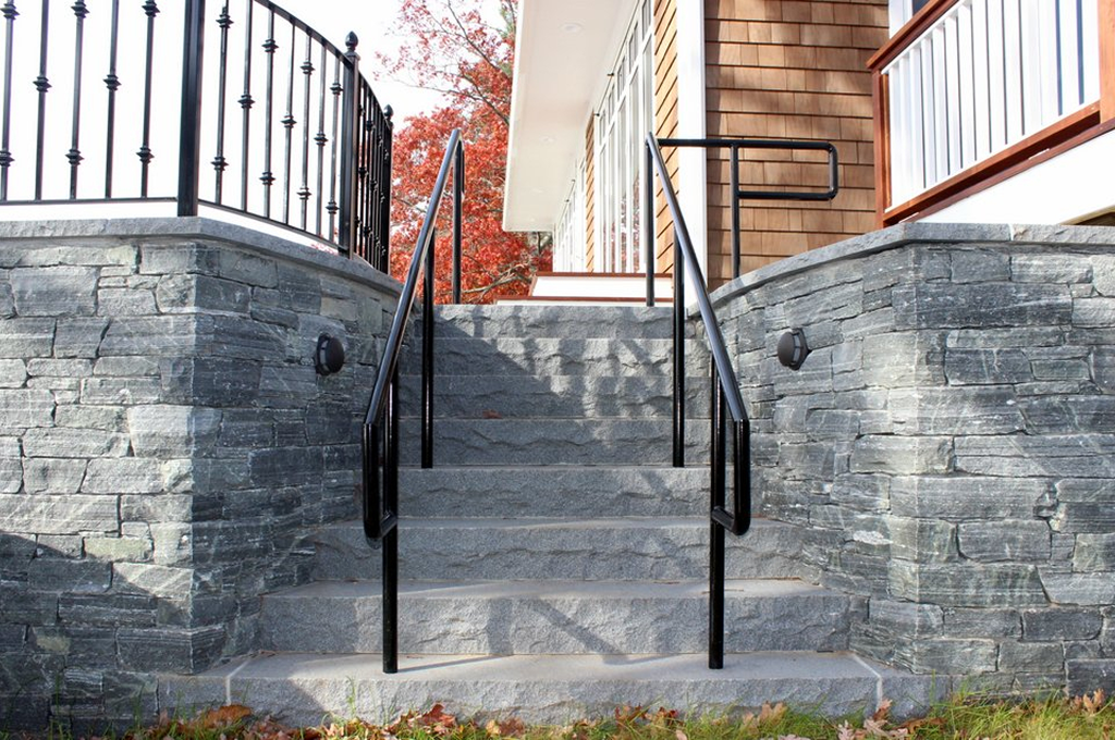 Outdoor stone steps with metal handrails