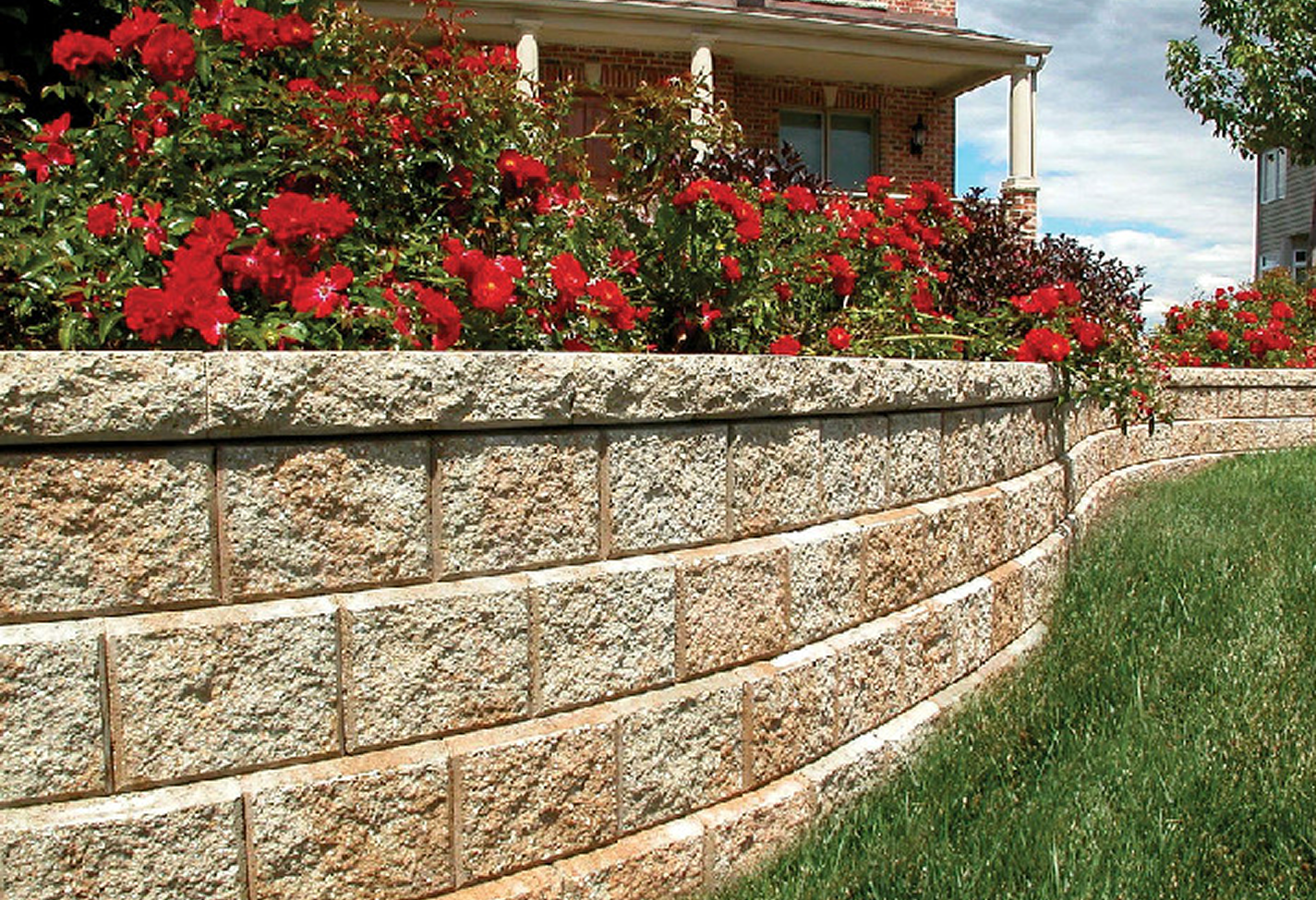 Stone retaining wall with red flowers