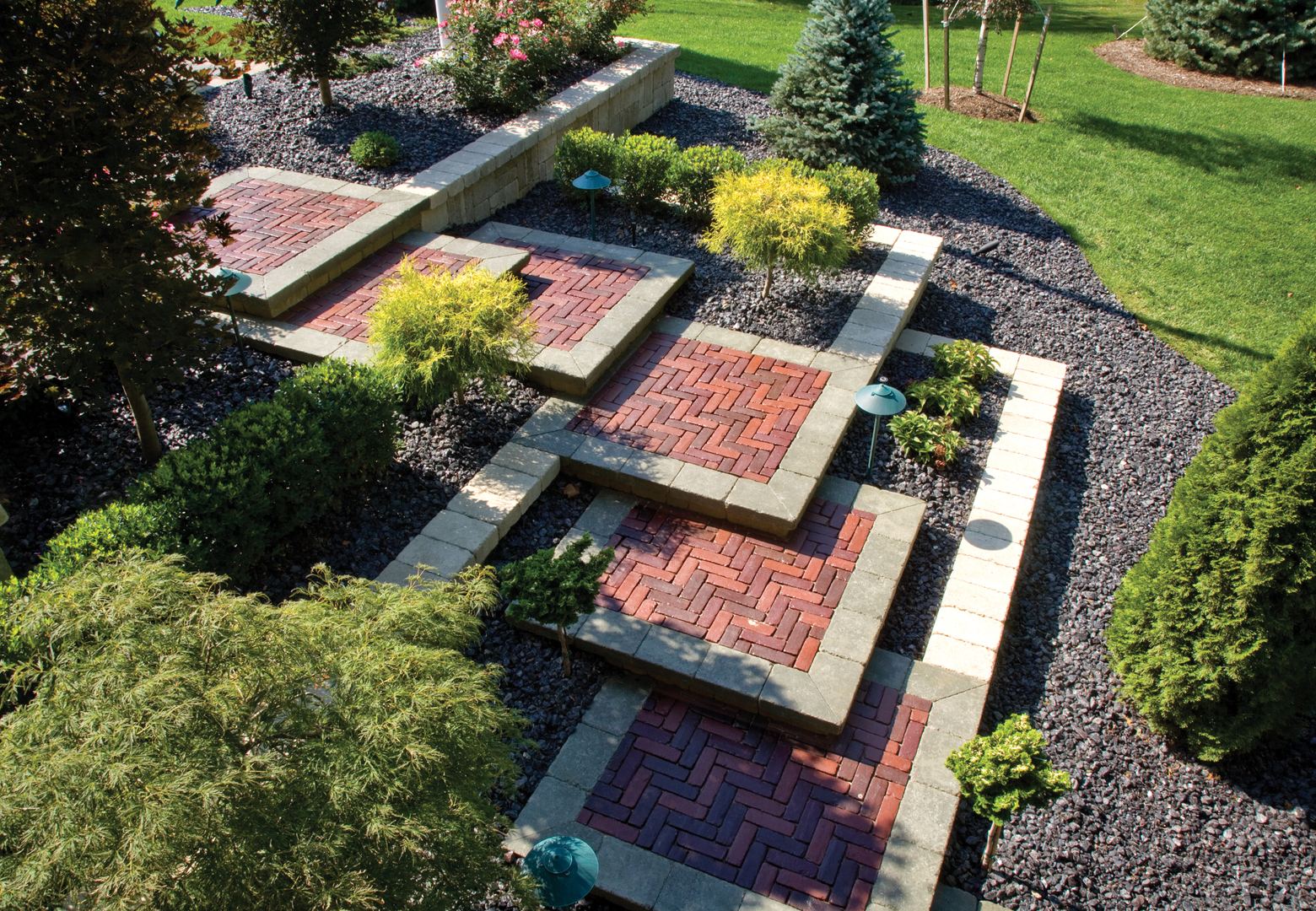 Brick garden path with decorative shrubs