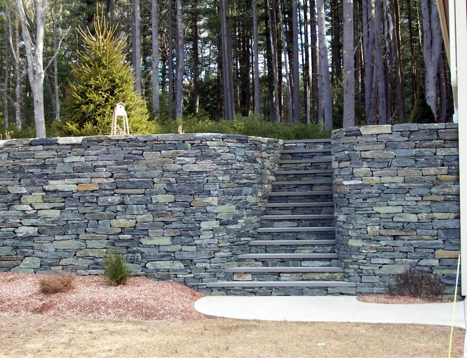 Stone wall with steps in garden