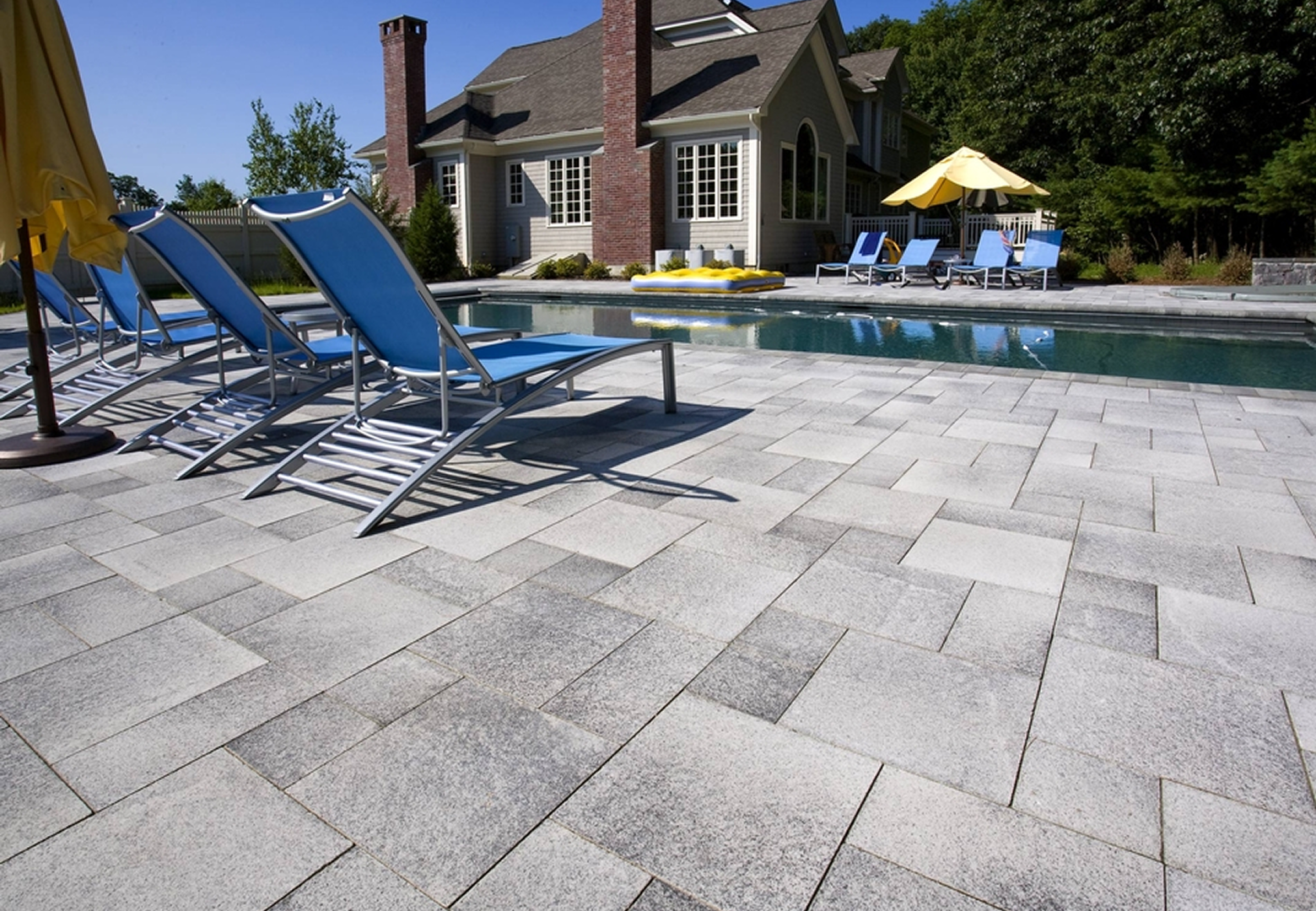 Relaxing poolside setting with blue chairs