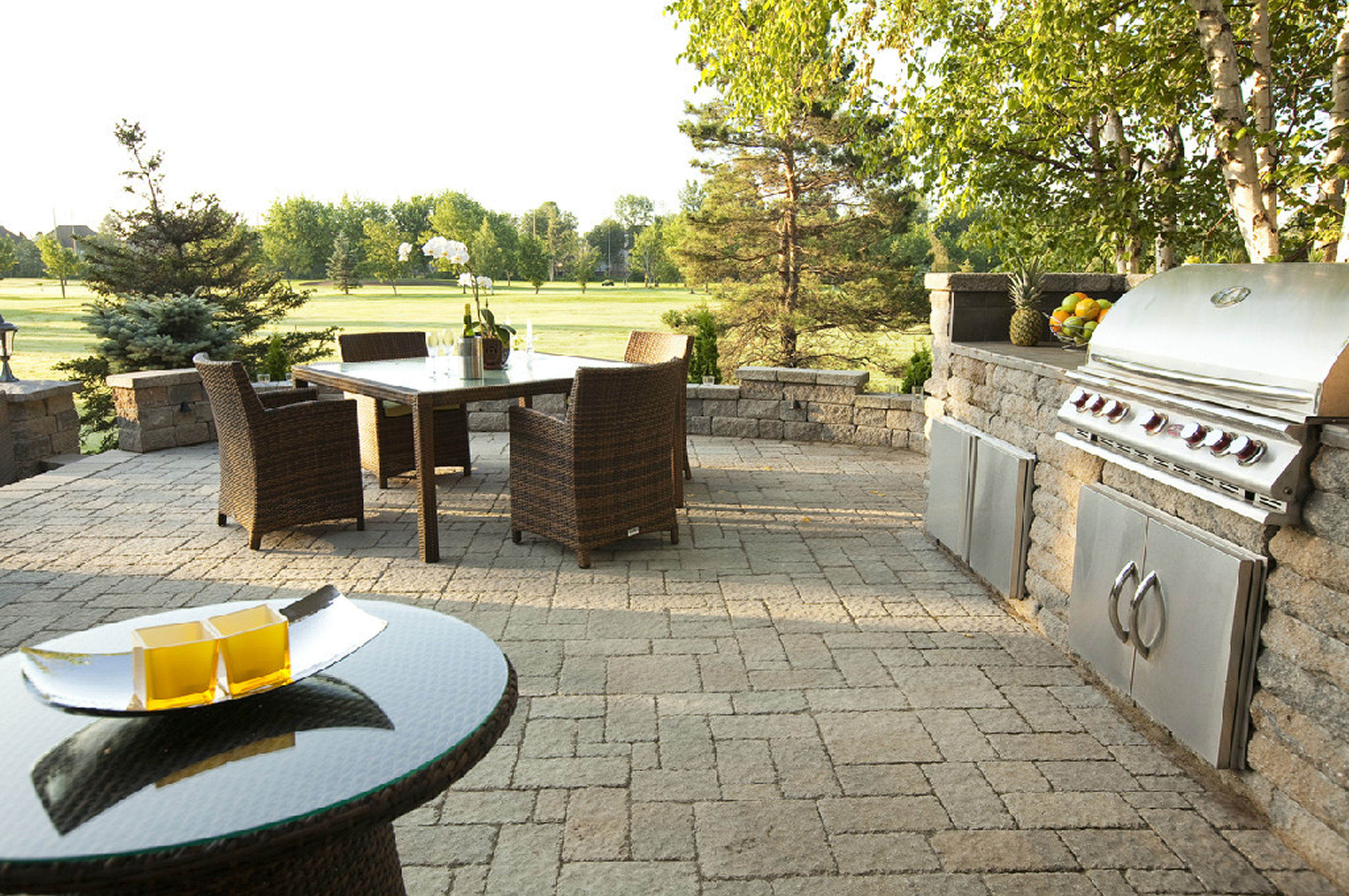 Outdoor patio with dining set and grill.
