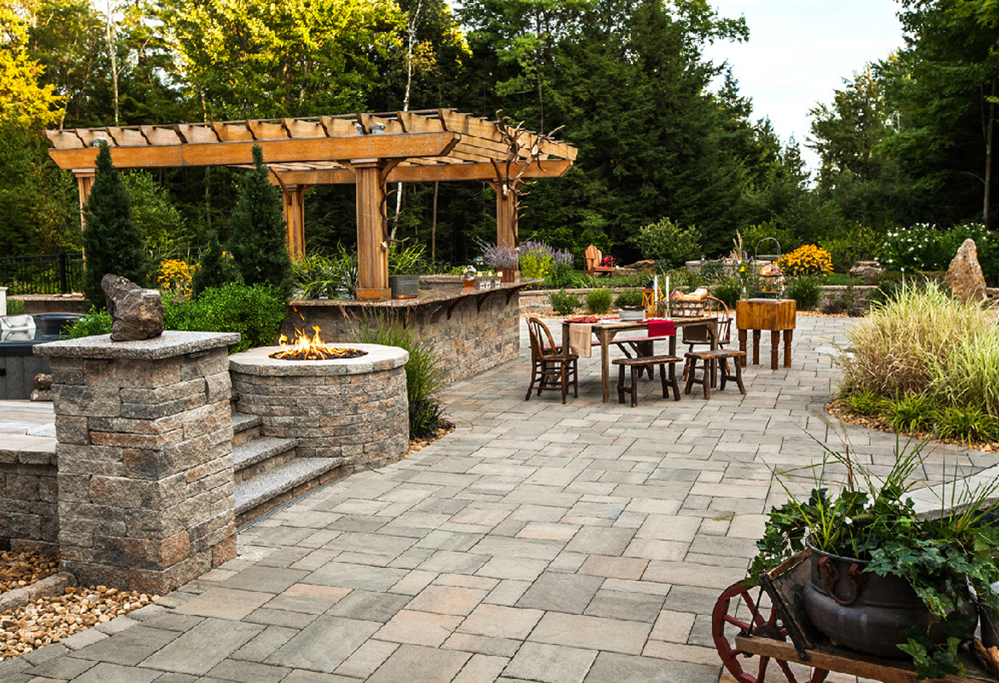 Garden patio featuring wooden pergola and landscaping