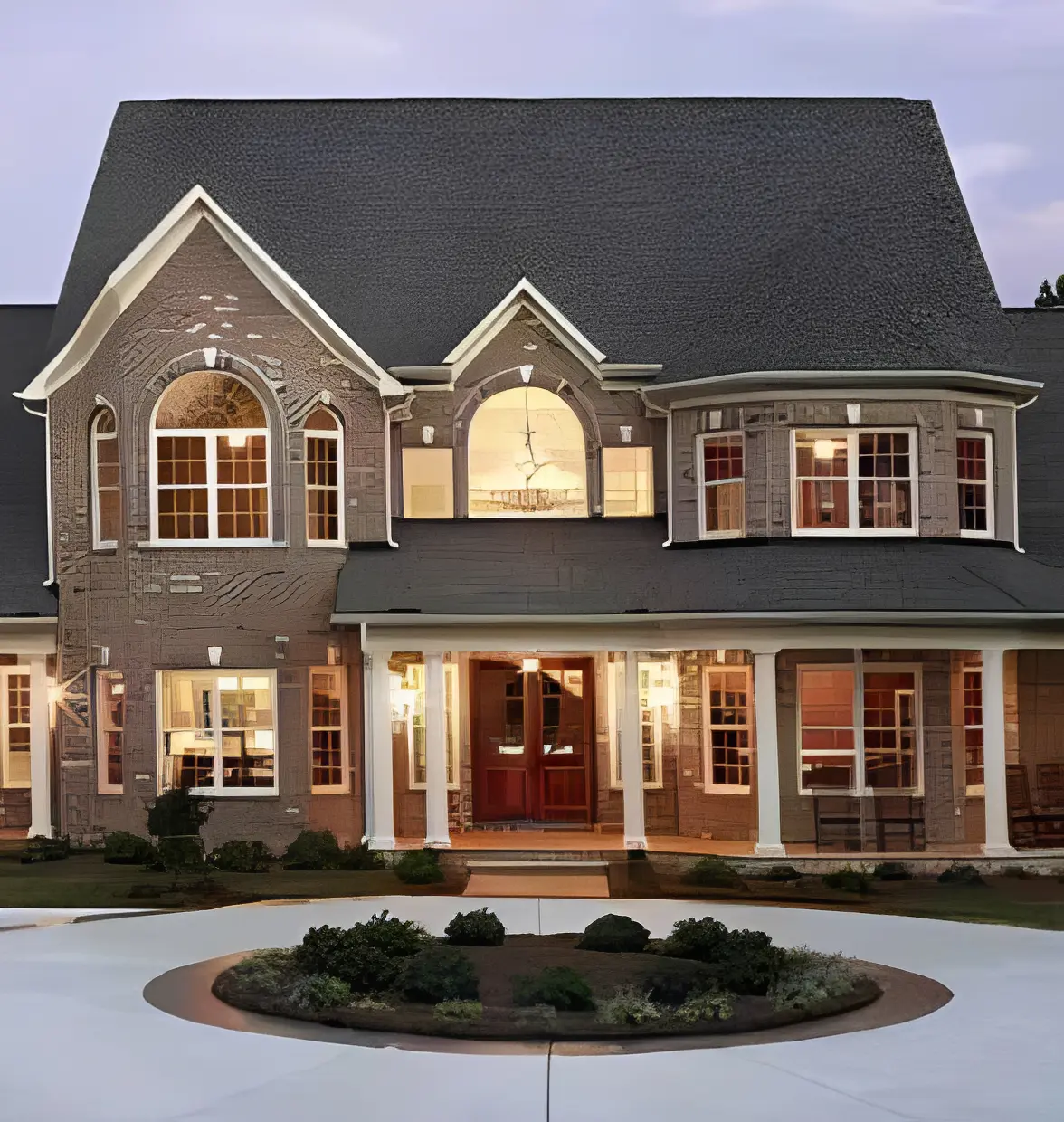 Large two-story home with lights on