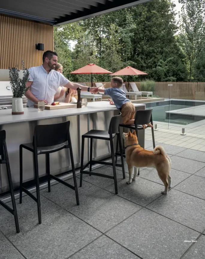 Man and child at outdoor bar with dog