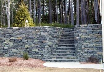 Stone wall with stairs in forest