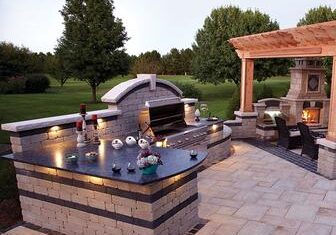 Outdoor kitchen with grill and seating area