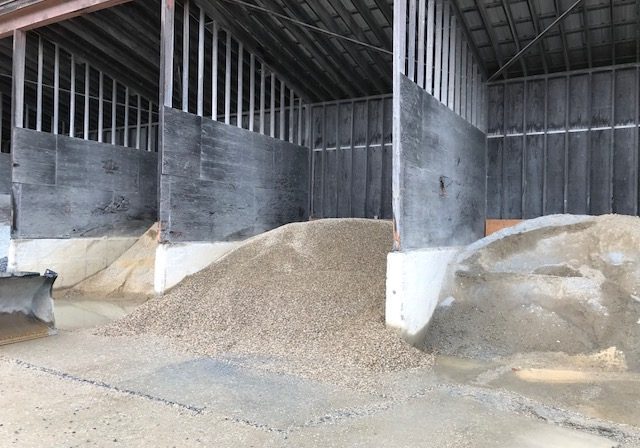 Gravel stored under a wooden shelter